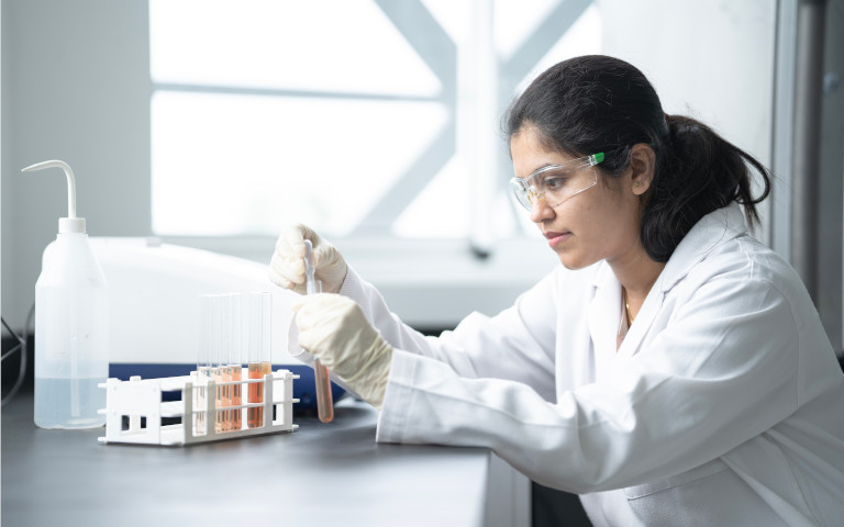 A female researcher working in the laboratory with test tubes